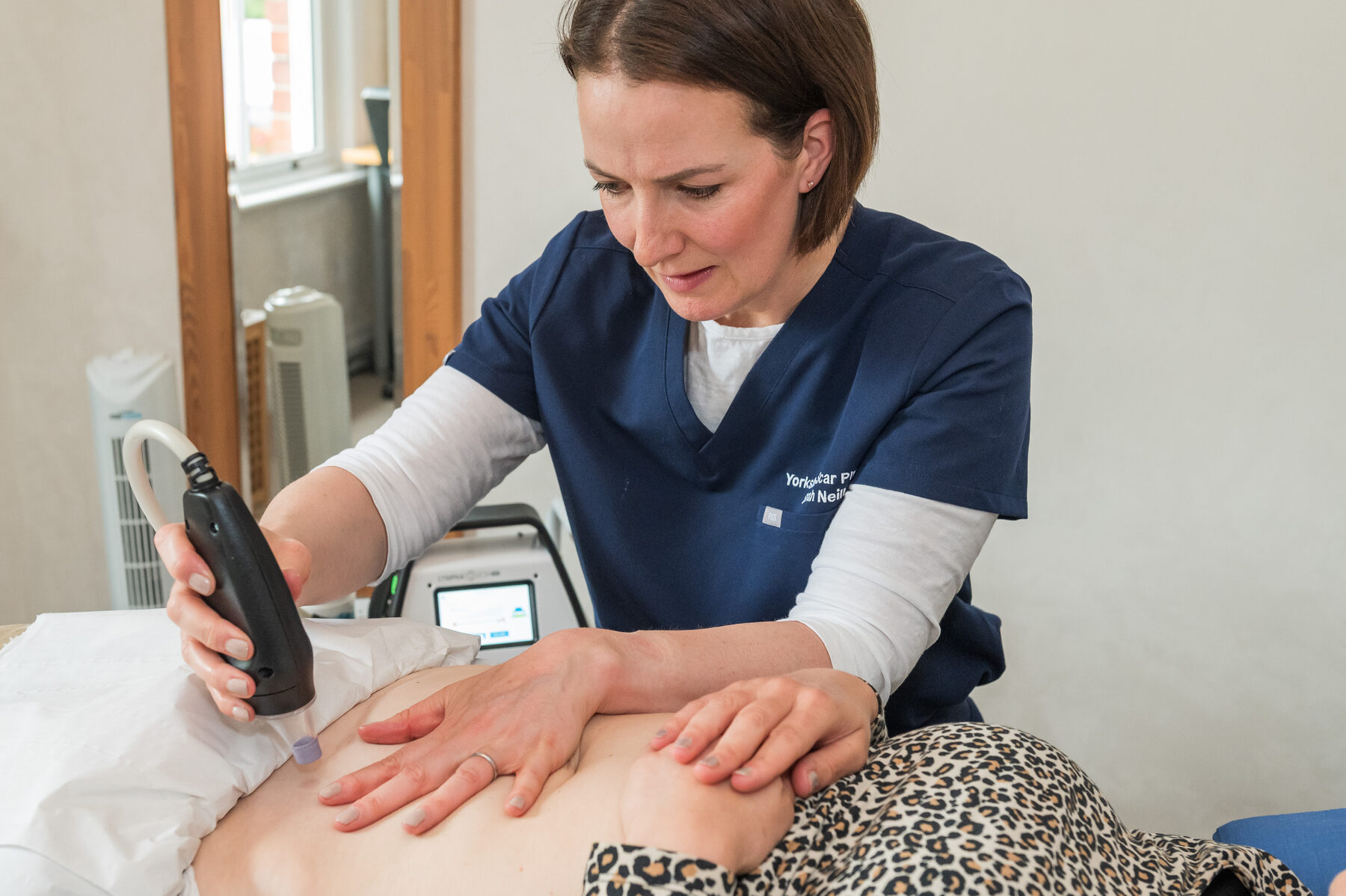 Sarah using the LymphaTouch Pro device during a scar therapy session