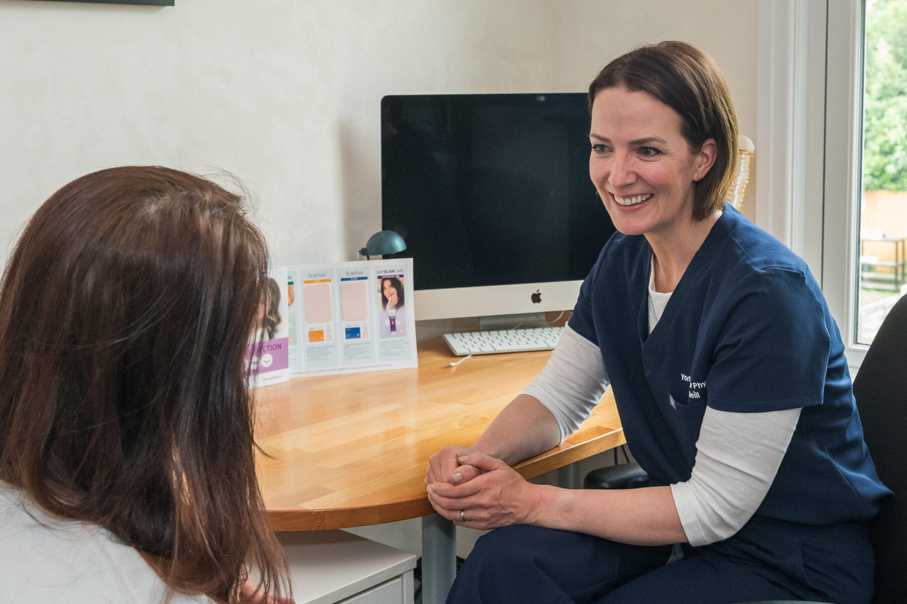 Sarah Neill chatting with a patient during a consultation